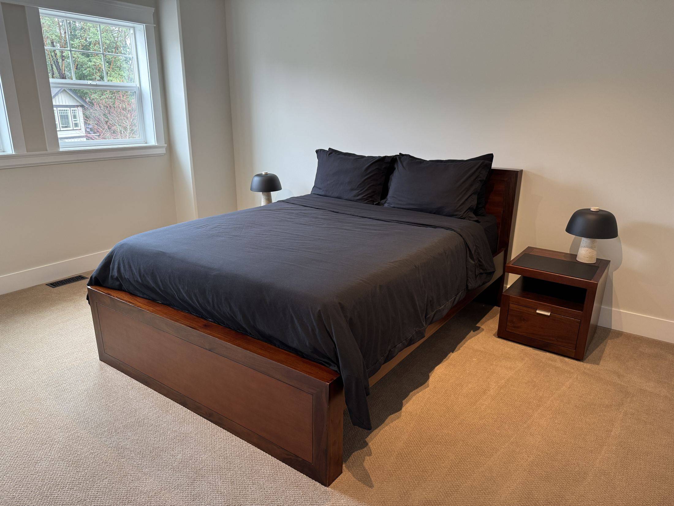 The charcoal room: queen bed in dark wood