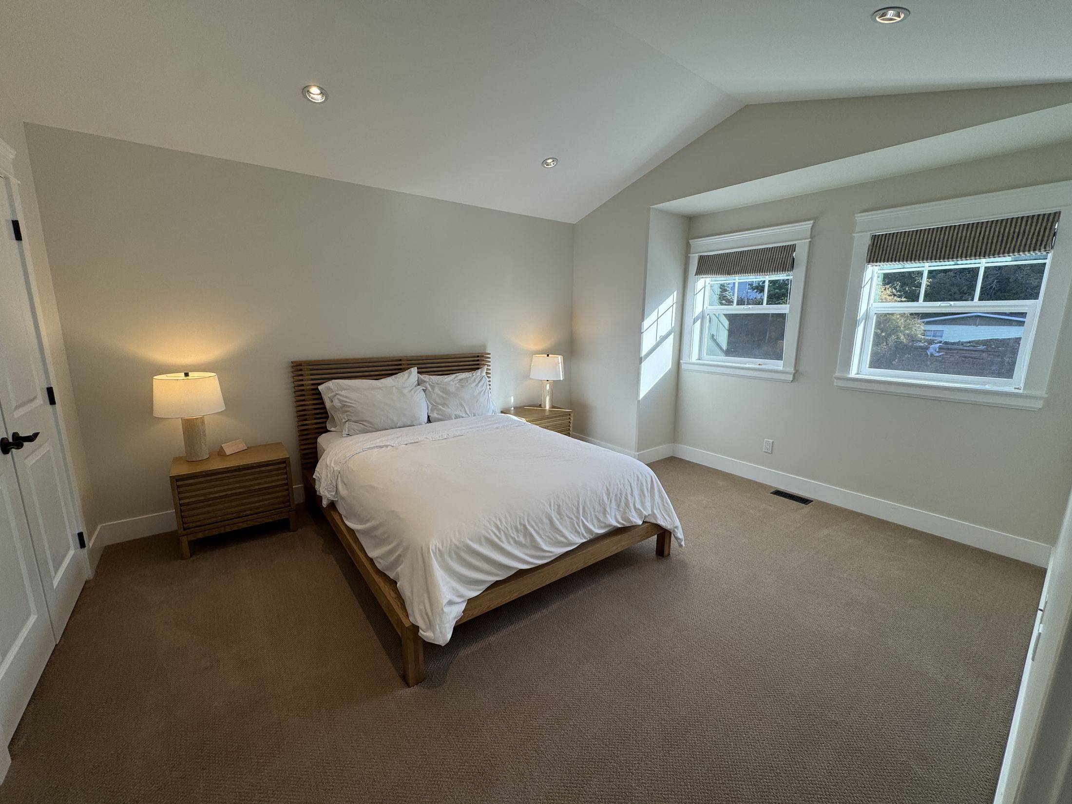 The oak room: queen bed under a vaulted ceiling, with a window bay